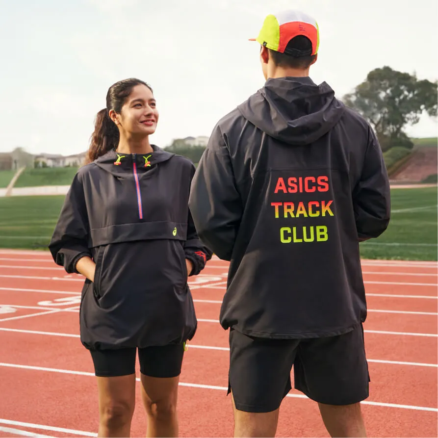 two ASICS athletes in ASICS Track Club black jackets on an outdoor track